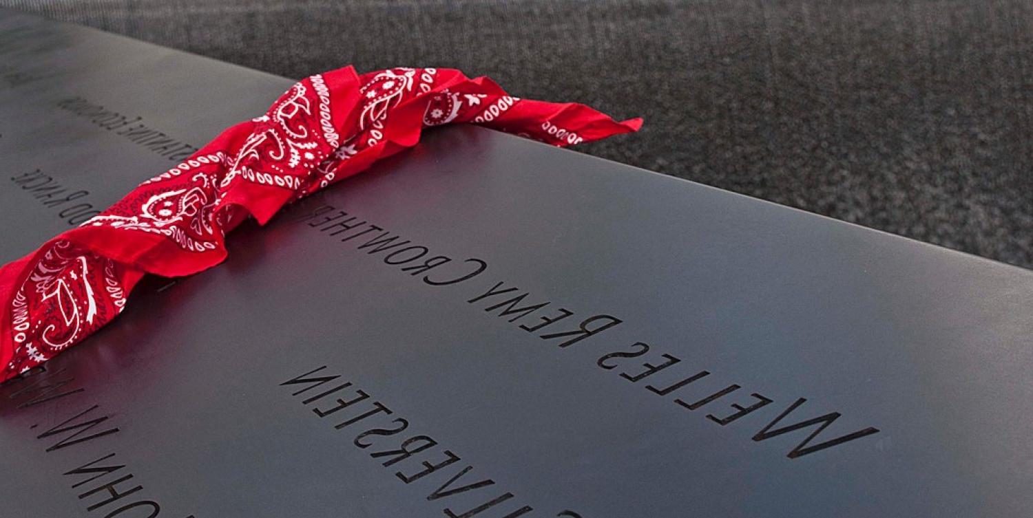 A red bandana draped over a granite marker