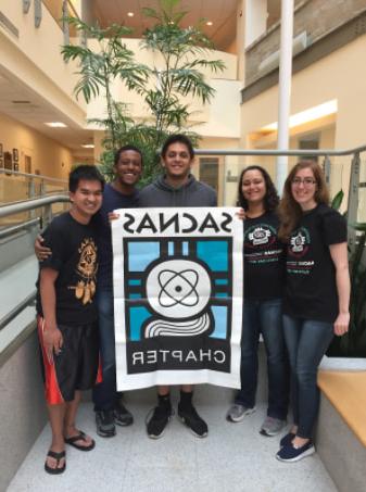 people holding up a SACNAS banner