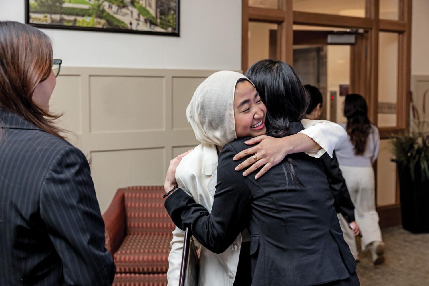 Student scholarship winner hugs a family member