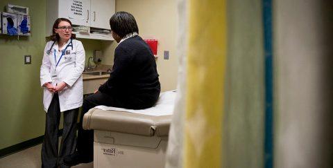 a nursing student with a patient in a clinical setting